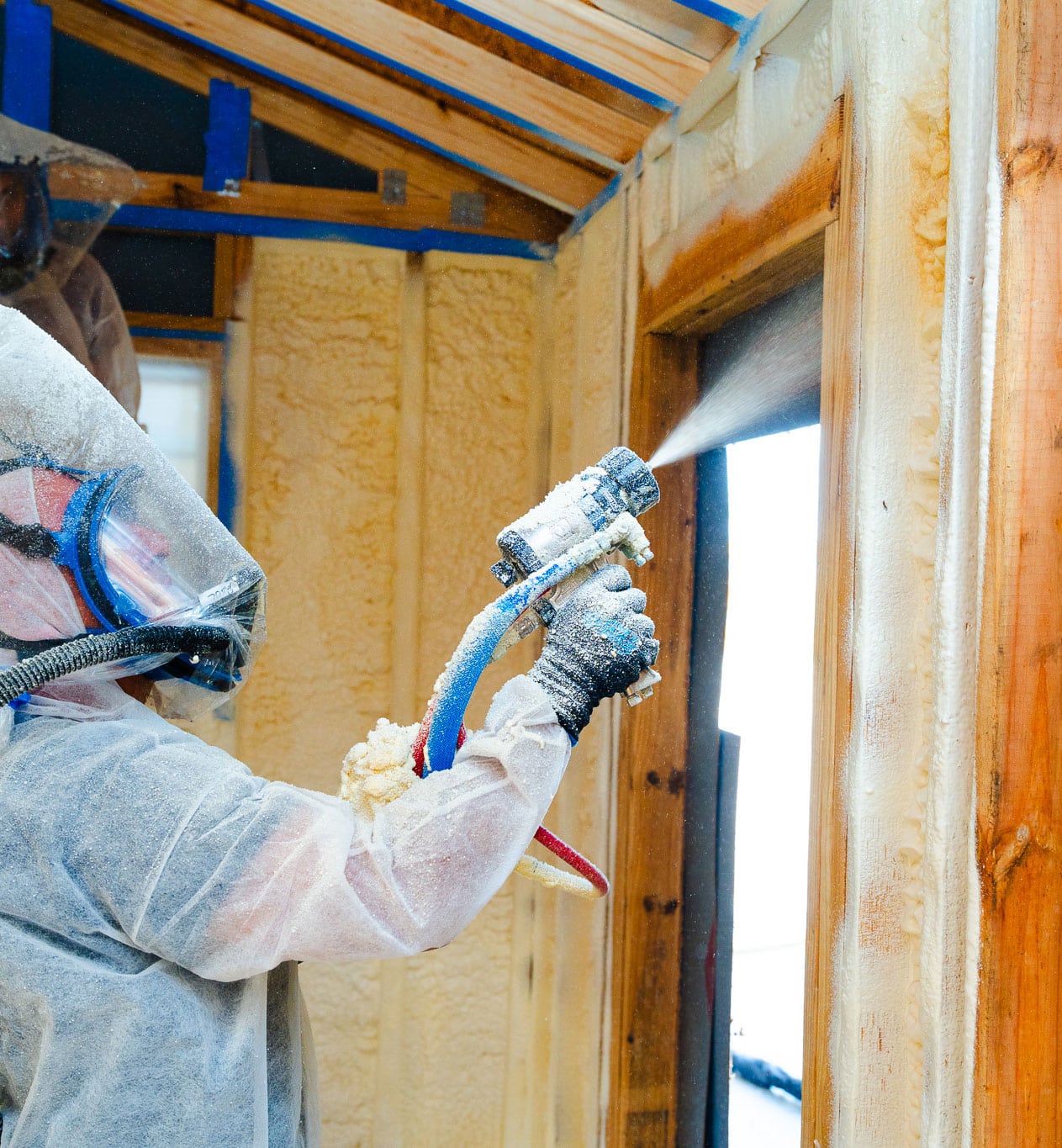 Spray foam insulation being applied inside a shed